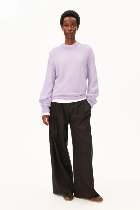 Model trägt den Mohair-Mix Strickpullover Moonlit Lilac kombiniert mit dunkler Hose
