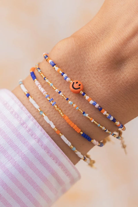 Armband mit 24k vergoldeten Metallteilen und Smiley-Perle