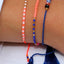 Armband Sweet String Orange Sprinkles Blush Indigo, kombiniert mit anderen Bändchen, Sprinkles-Mix aus Coral, Weiß, Indigo und Gold