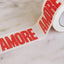 Klebeband AMORE NAVUCKO – Detailansicht AMORE-Design auf Papierklebeband in Naturweiß/Rot