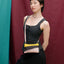 The New Pouch Multi Black Small von Susan Bijl, Vorderseite, diagonale Farbflächen in Gelb, Schwarz und Zartrosa, gelber YKK-Reißverschluss