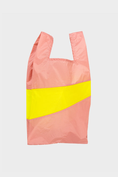 Die Neue Einkaufstasche in Lachsfarbe mit einem gelben Streifen - umweltbewusst und stylish